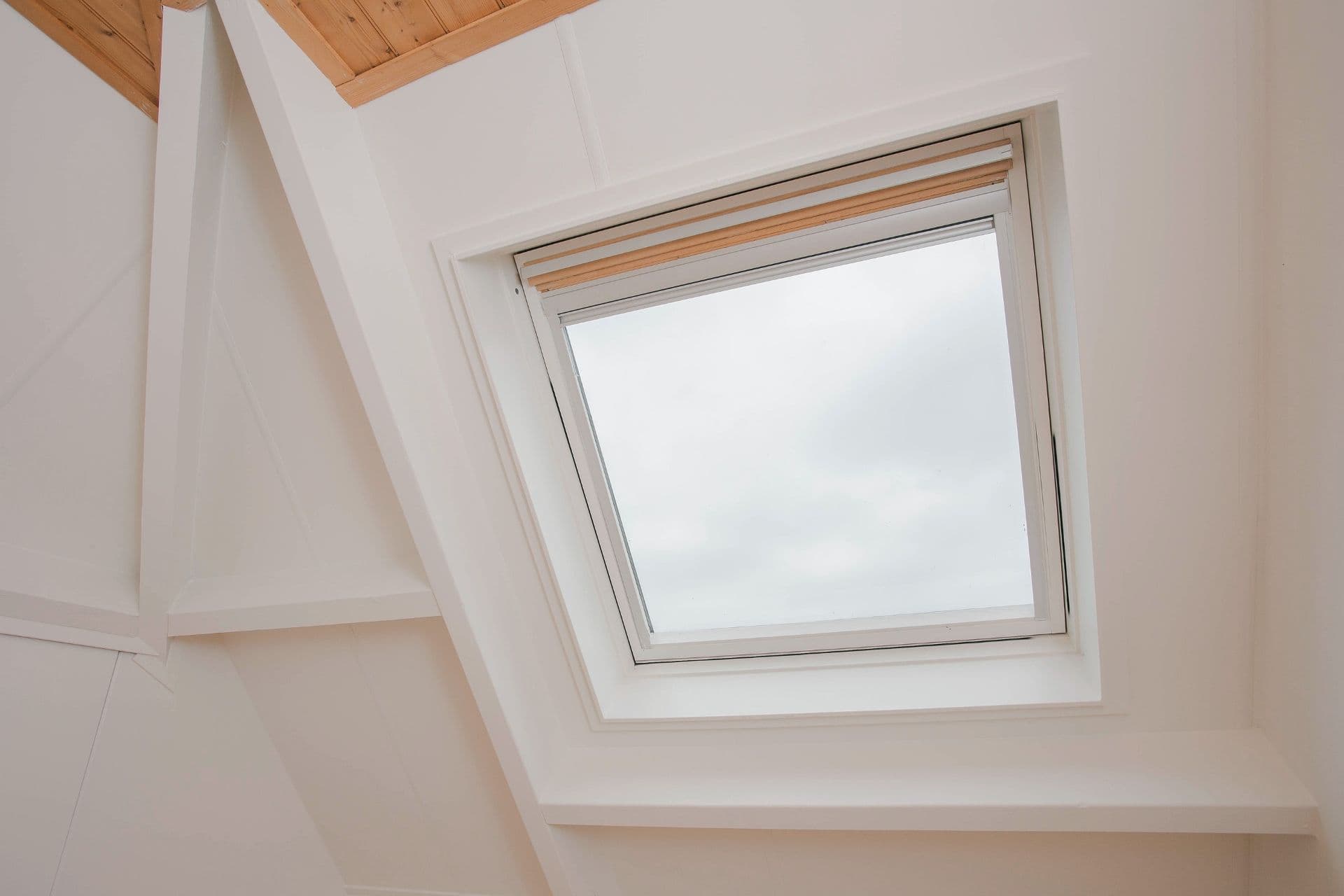 A square skylight framed by a white ceiling lets in diffused natural light.